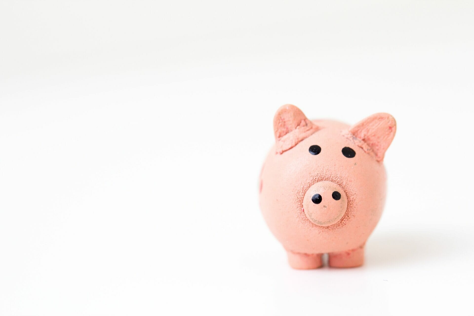 Pink piggy bank on a white background representing recurring vs. re-occuring revenue.