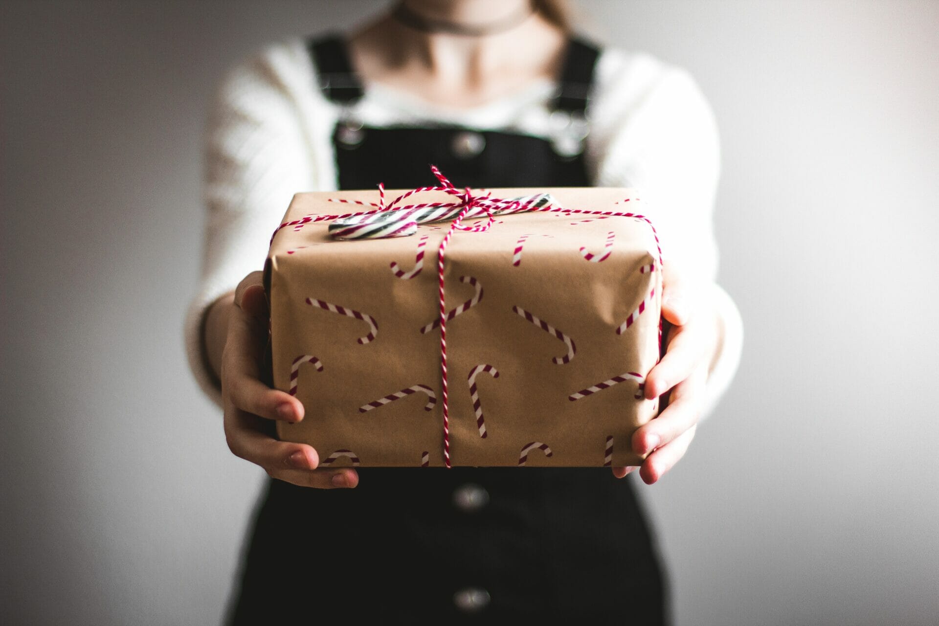 Person handing a present showing "selling your business"