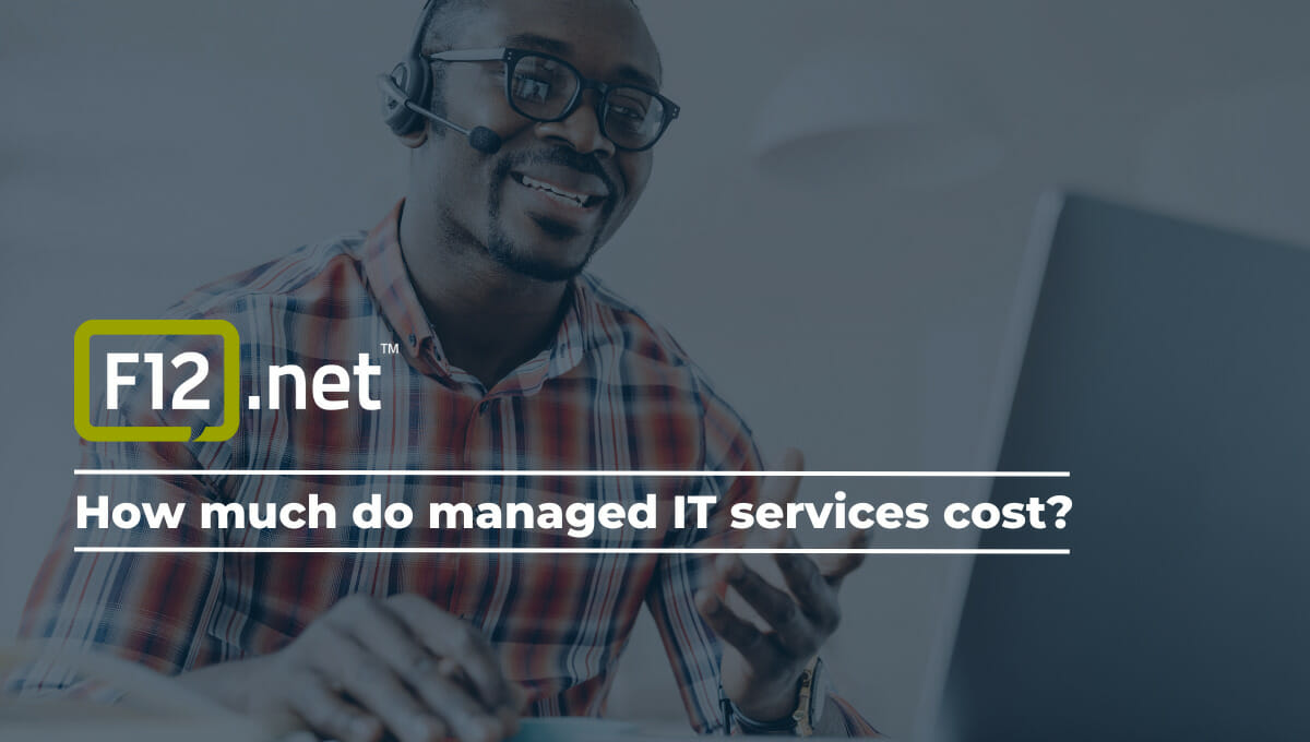 Close-up of an African American man happily providing managed IT services customer support on a laptop