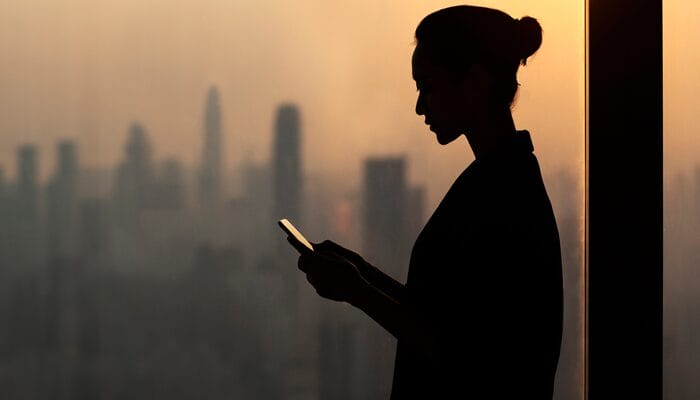 An image of a Canadian IT executive on her Iphone being informed of a cyberattack on her organization.