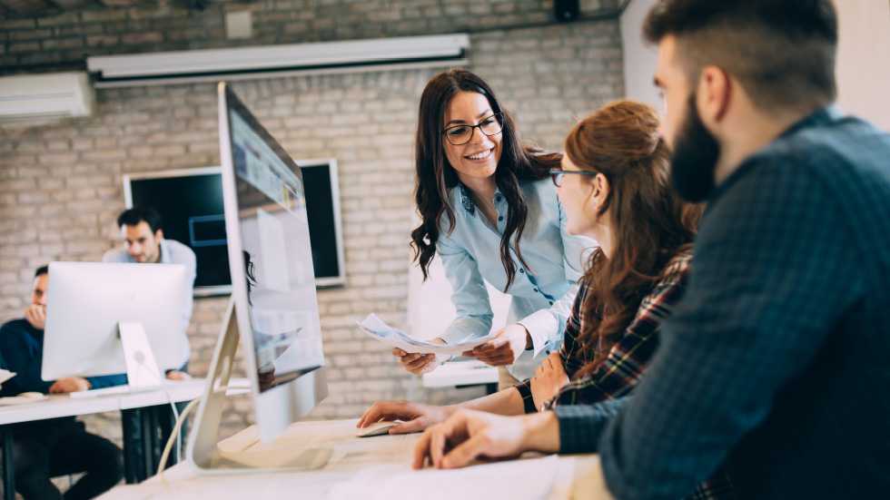 F12.Sovereign-Cloud-Services.people-office Female warehouse manager working on a laptop